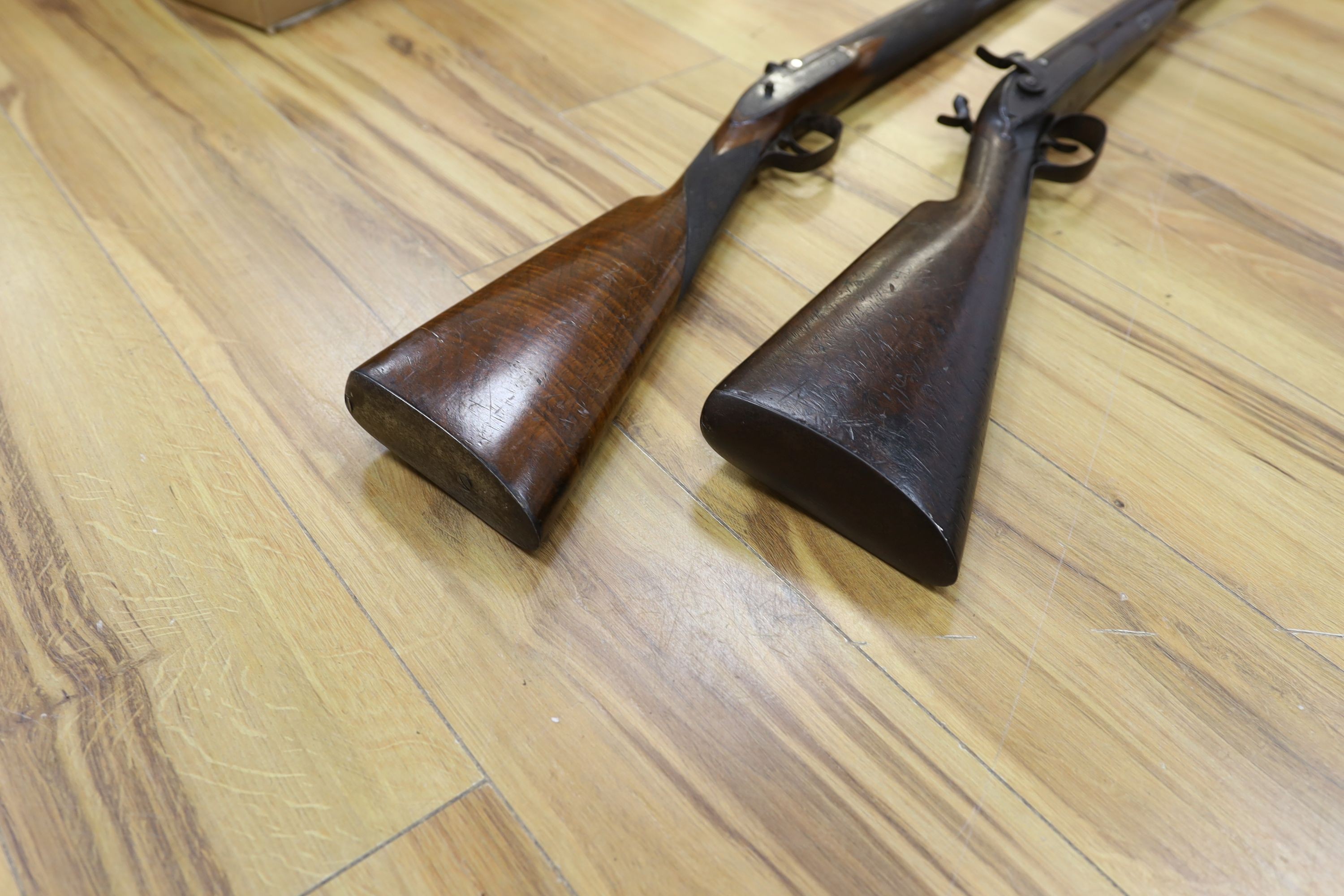 Two 19th century percussion muskets, 103cm. max., one double-barrelled